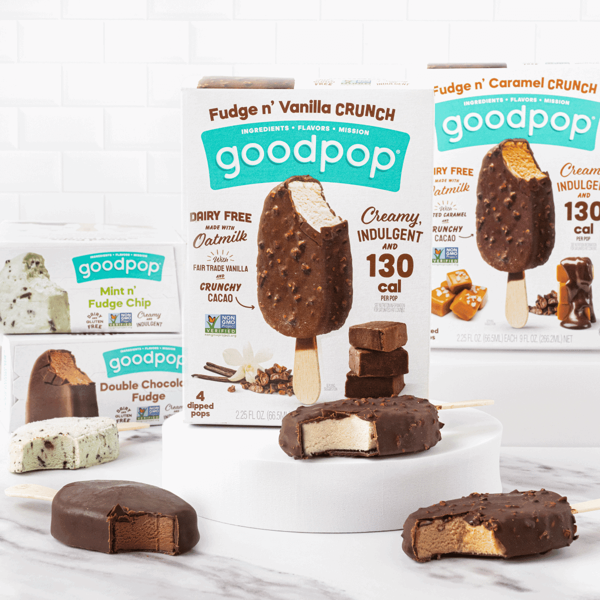 A product photo of GoodPop's new dipped bars on marble with the popsicles showing out of the box.